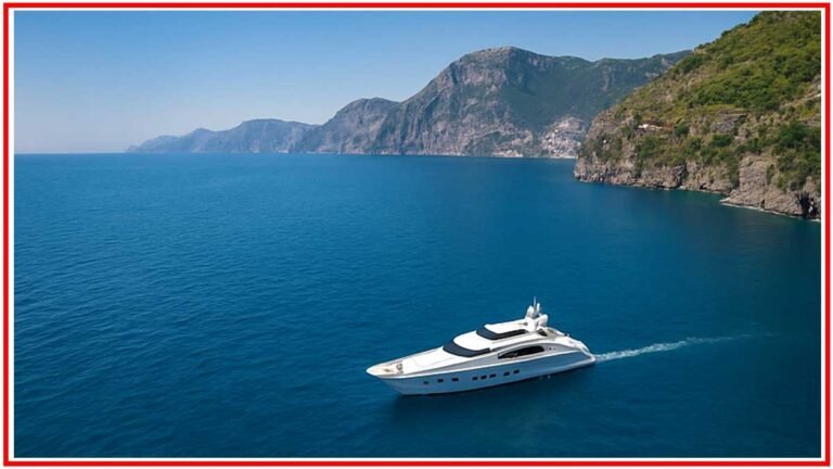 A sleek white yacht sailing along the Amalfi Coast under a brilliant blue sky in summer 2025.